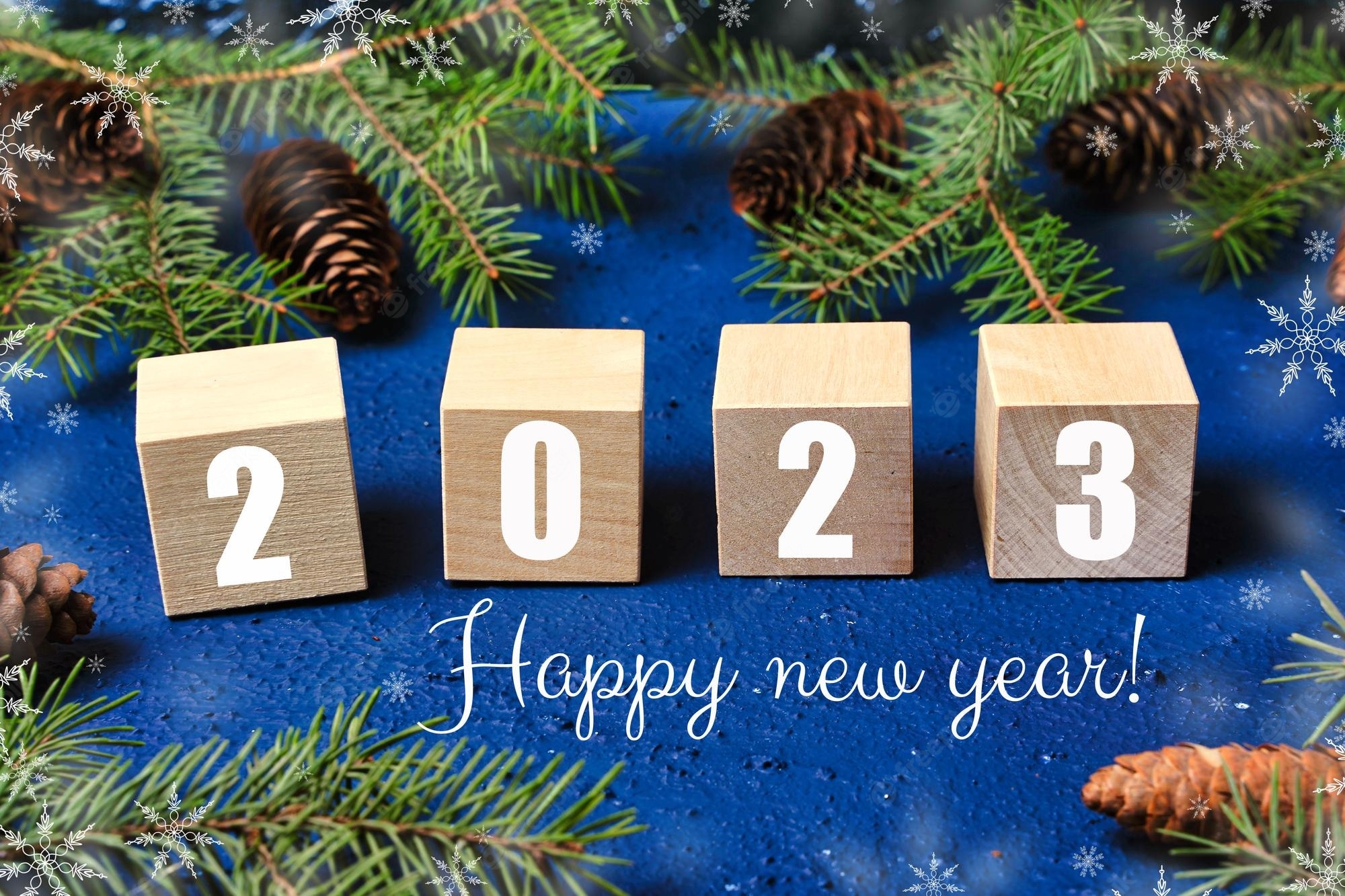 2000x1340 Premium Photo. Happy new year 2023 text sign on wooden cubes with frame of christmas tree branch and cones on red background snowflakes, Desktop