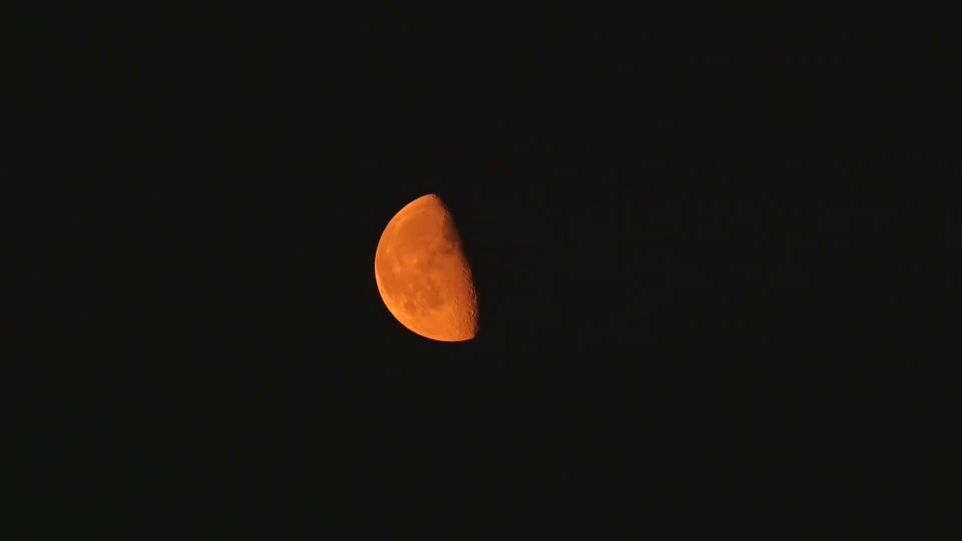 1920x1080 Orange waning gibbous moon against a black night sky Stock Video, Desktop