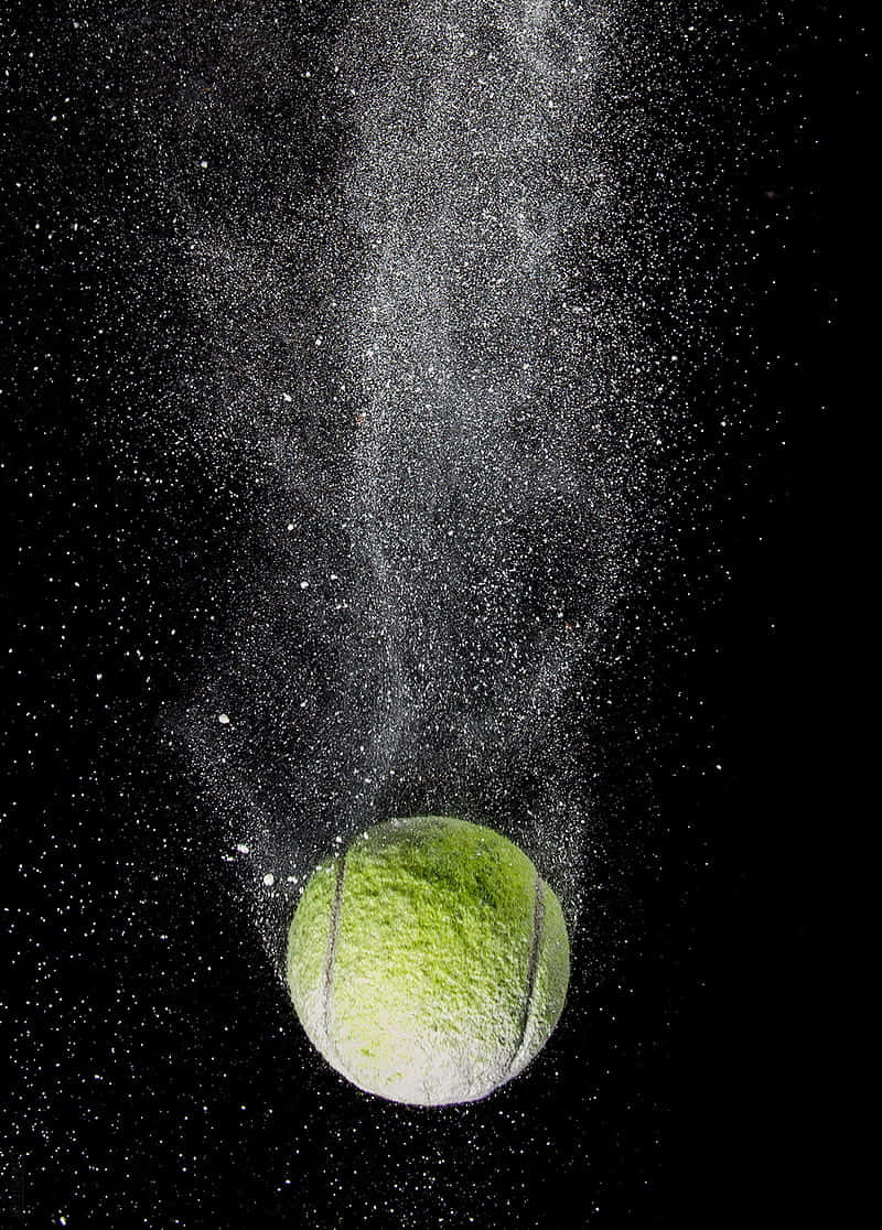 800x1120 Download A White Tennis Ball Resting Against An Off White Grass Surface Wallpaper, Phone