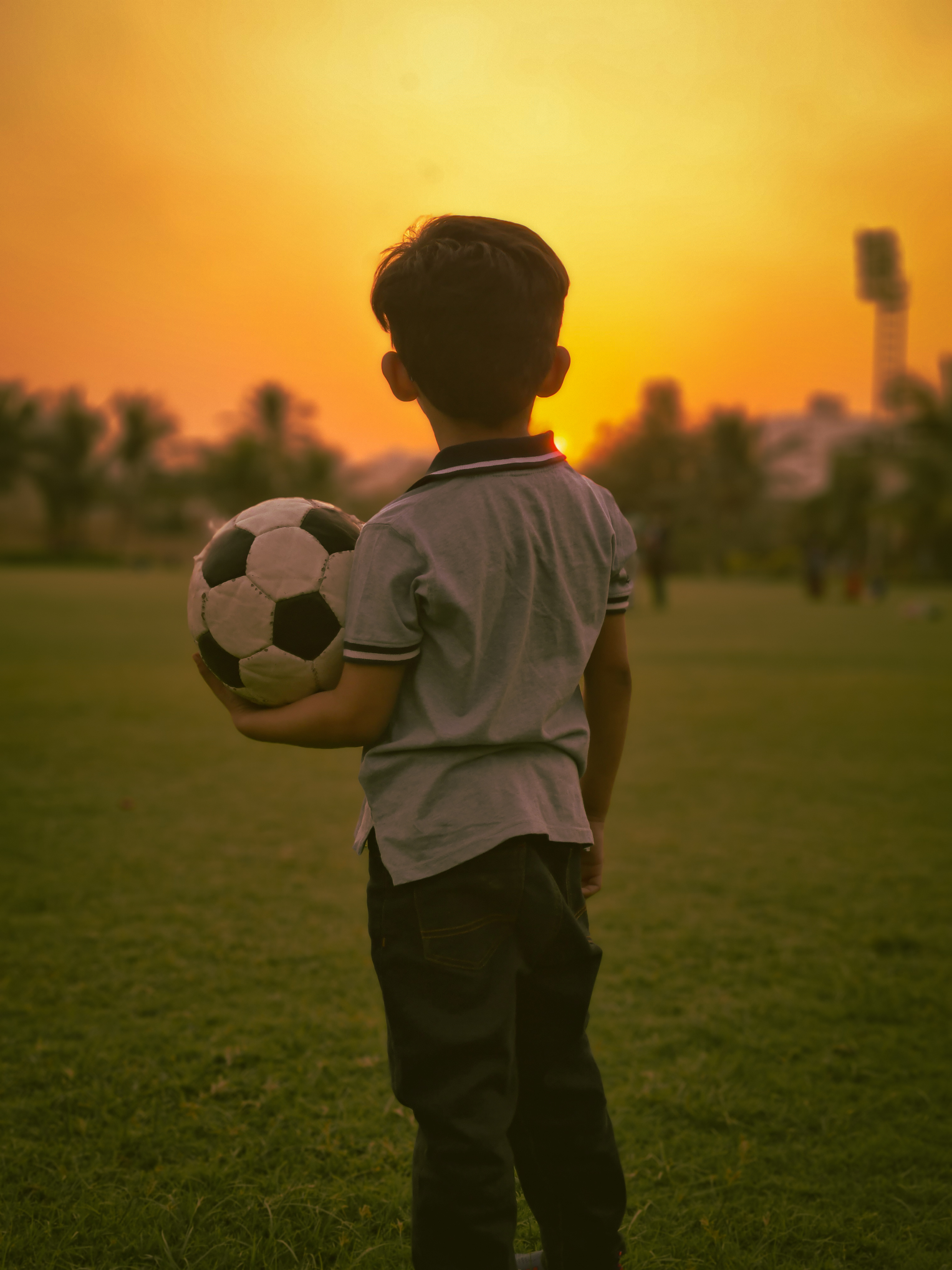 3030x4040 A Boy Holding a Football · Free, Phone