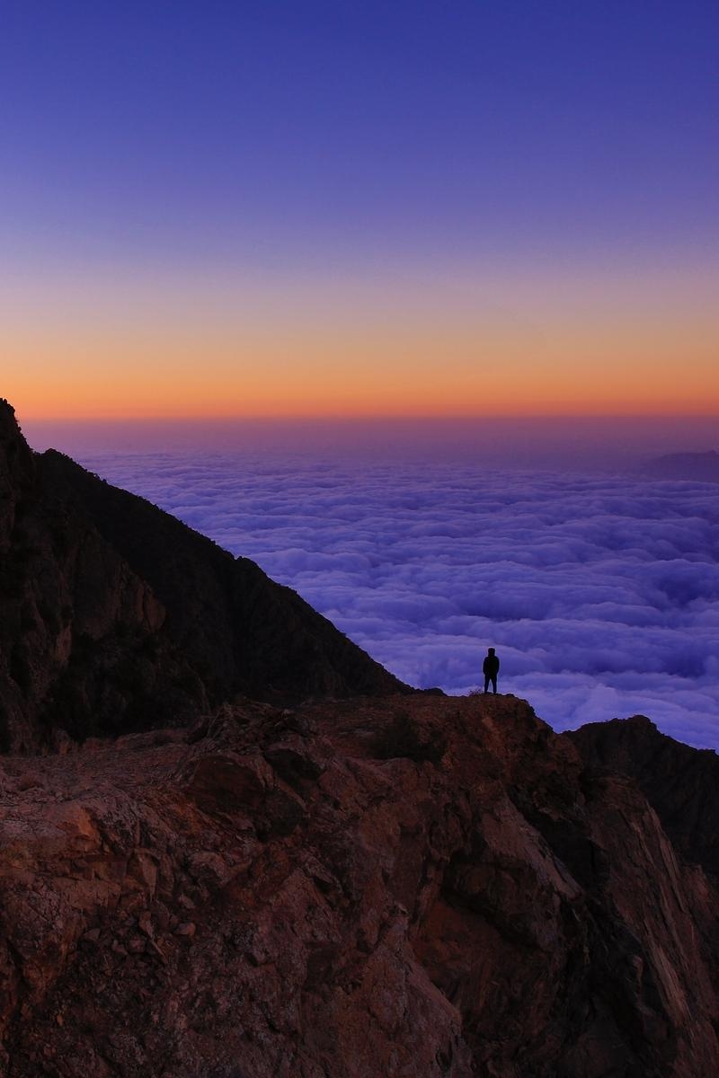 800x1200 Download wallpaper  mountain, man, loneliness, clouds, al, Phone