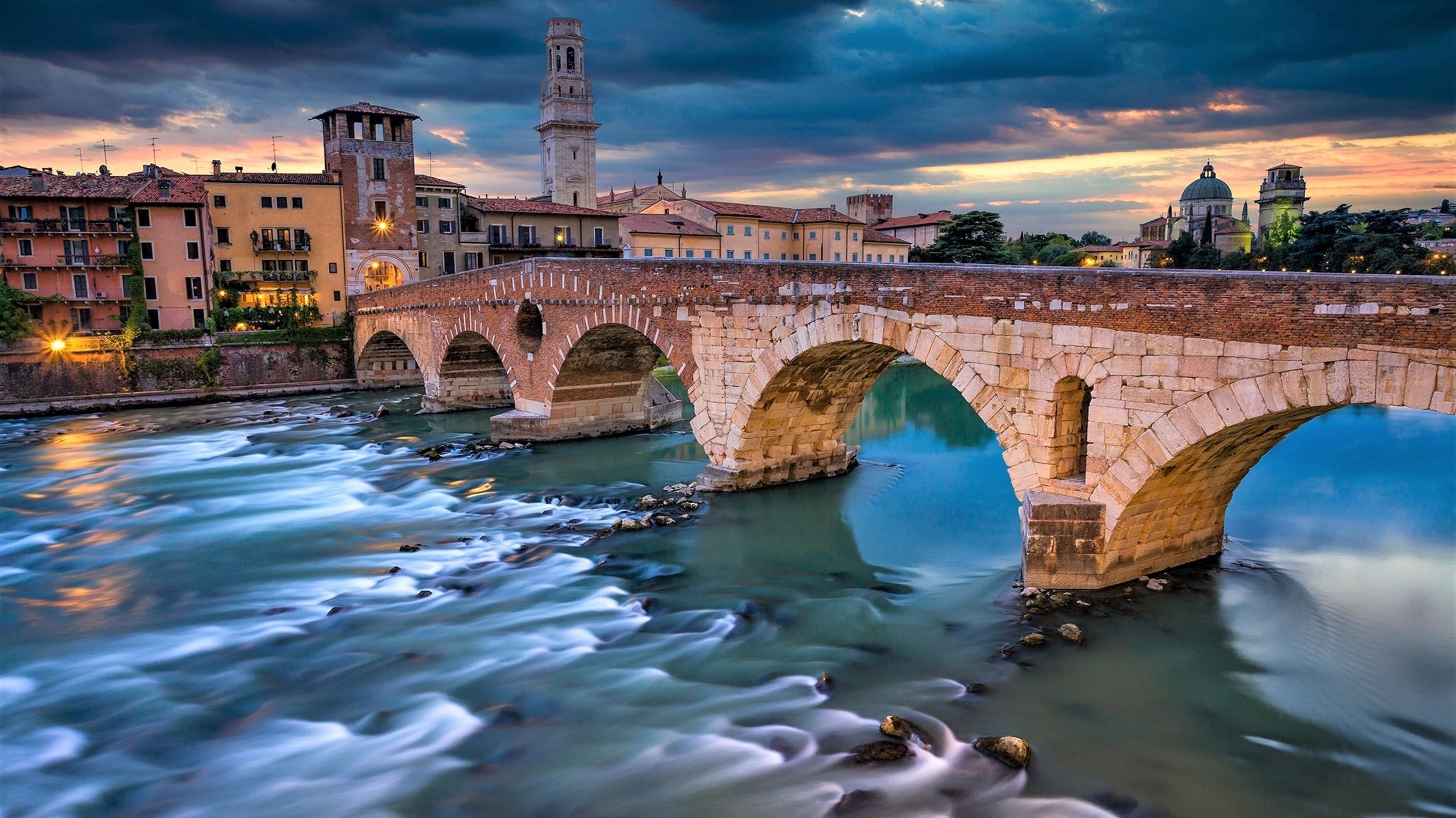 2740x1540 Download  Italy, Verona, Bridge, Dark Clouds, Buildings, Desktop