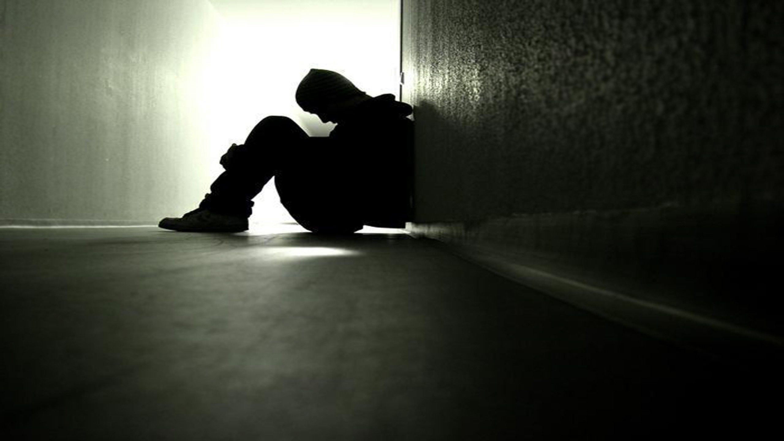 2560x1440 Sad boy sitting alone in dark wallpaper hd, Desktop