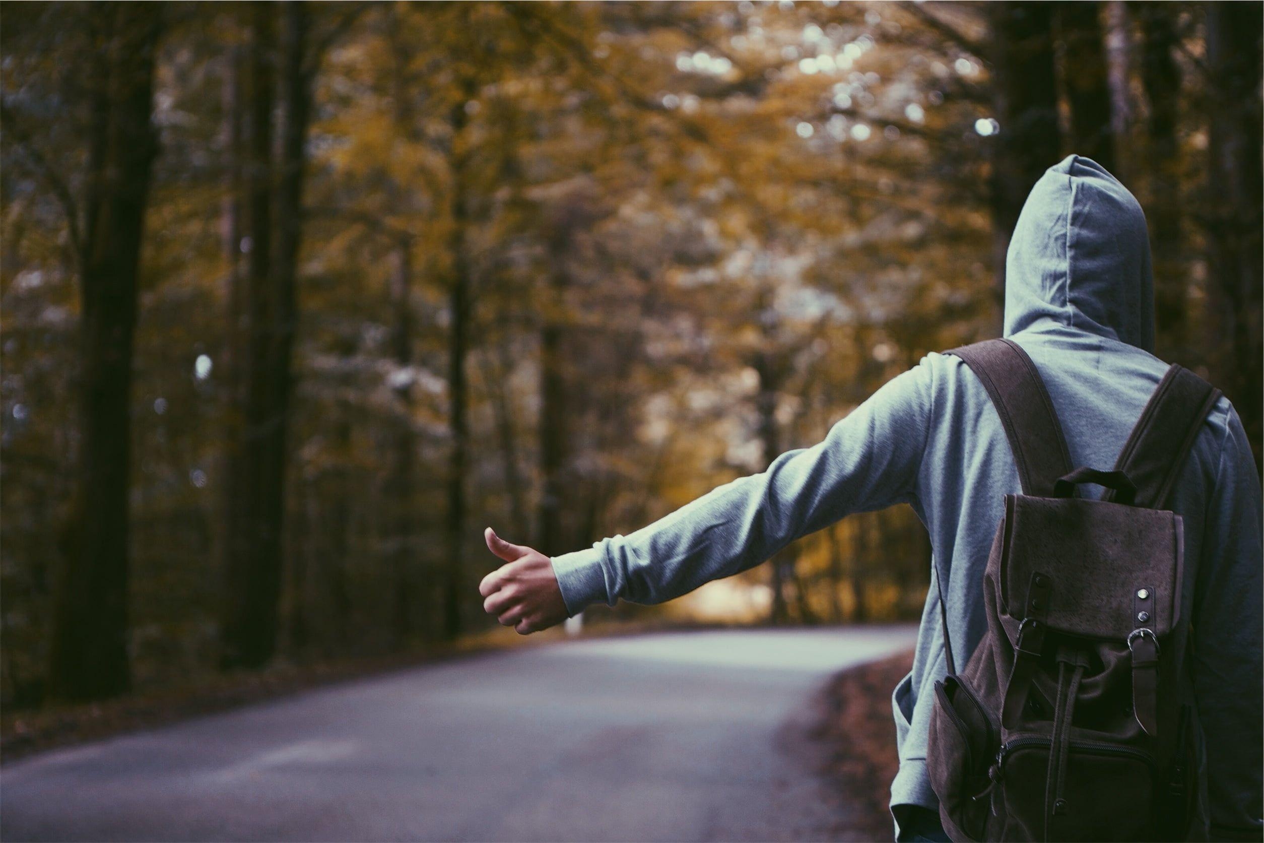 2510x1680 Person in gray hoodie wearing backpack standing on asphalt road HD, Desktop