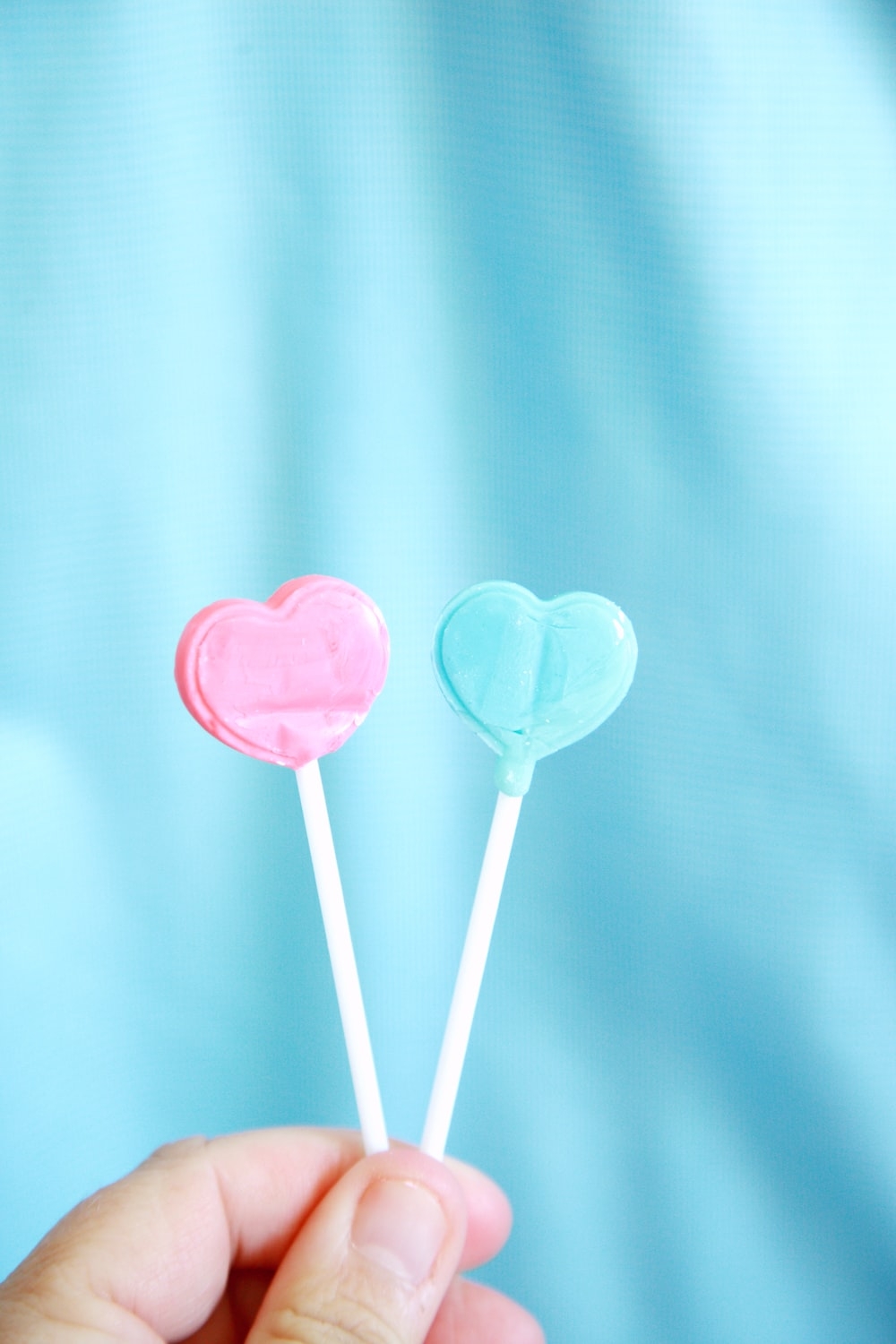 1000x1500 pink heart lollipop on white textile photo, Phone