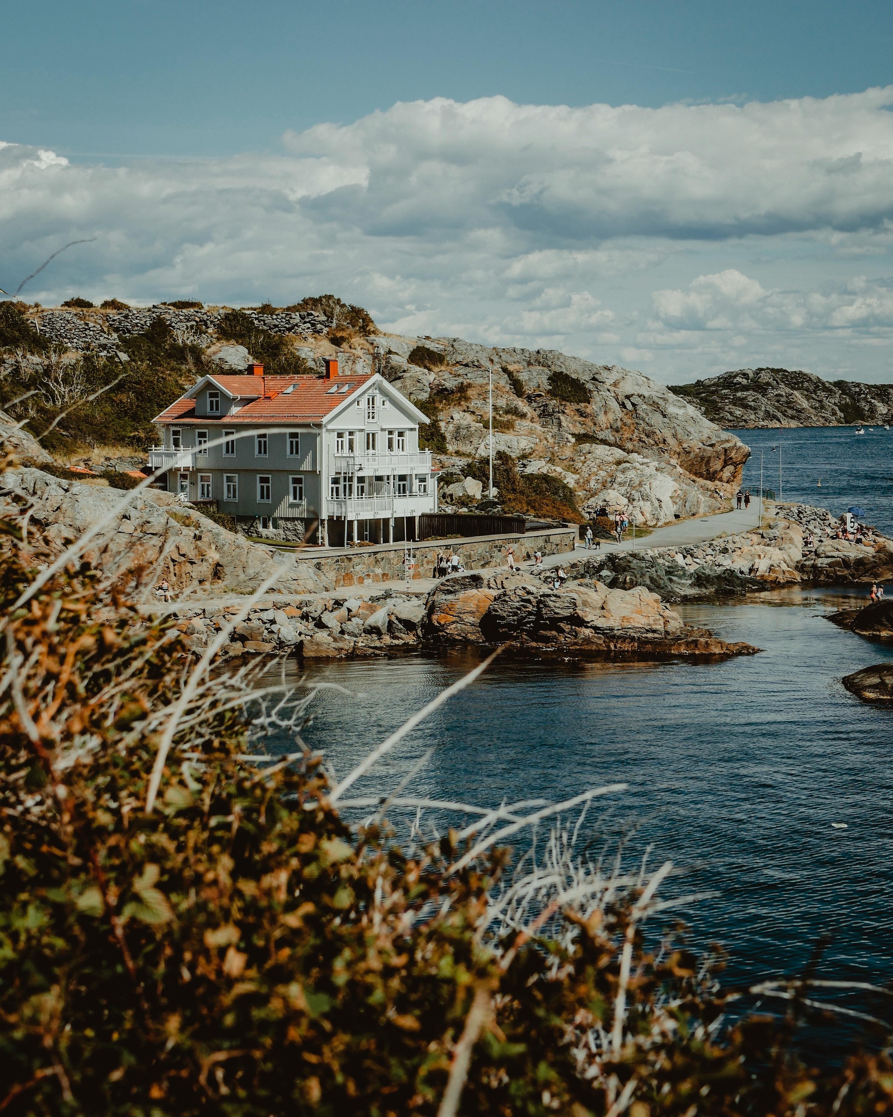 2950x3690 Download wallpaper  house, sea, shore, rocks, gothenburg, Phone