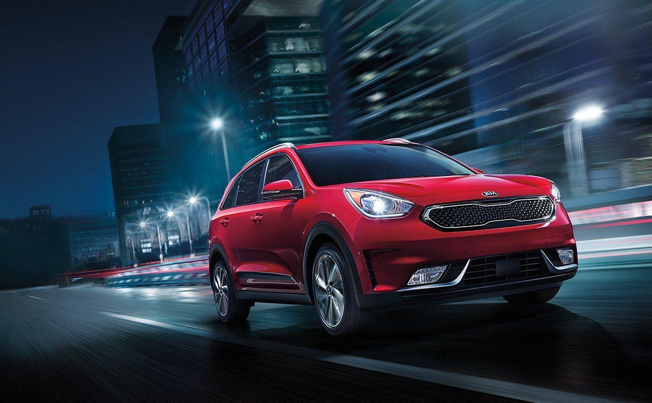 1280x800 Kia Niro EV red color night on road in city lights background, Desktop