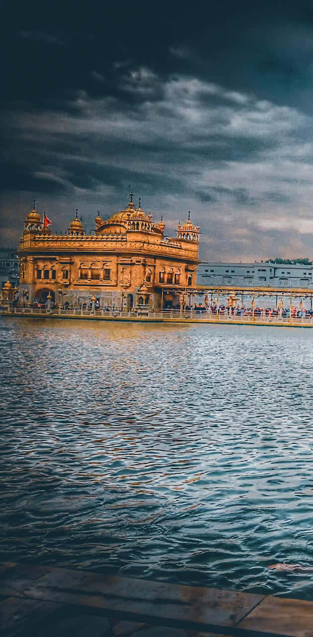 630x1280 Golden Temple On A Stormy Day Wallpaper, Phone