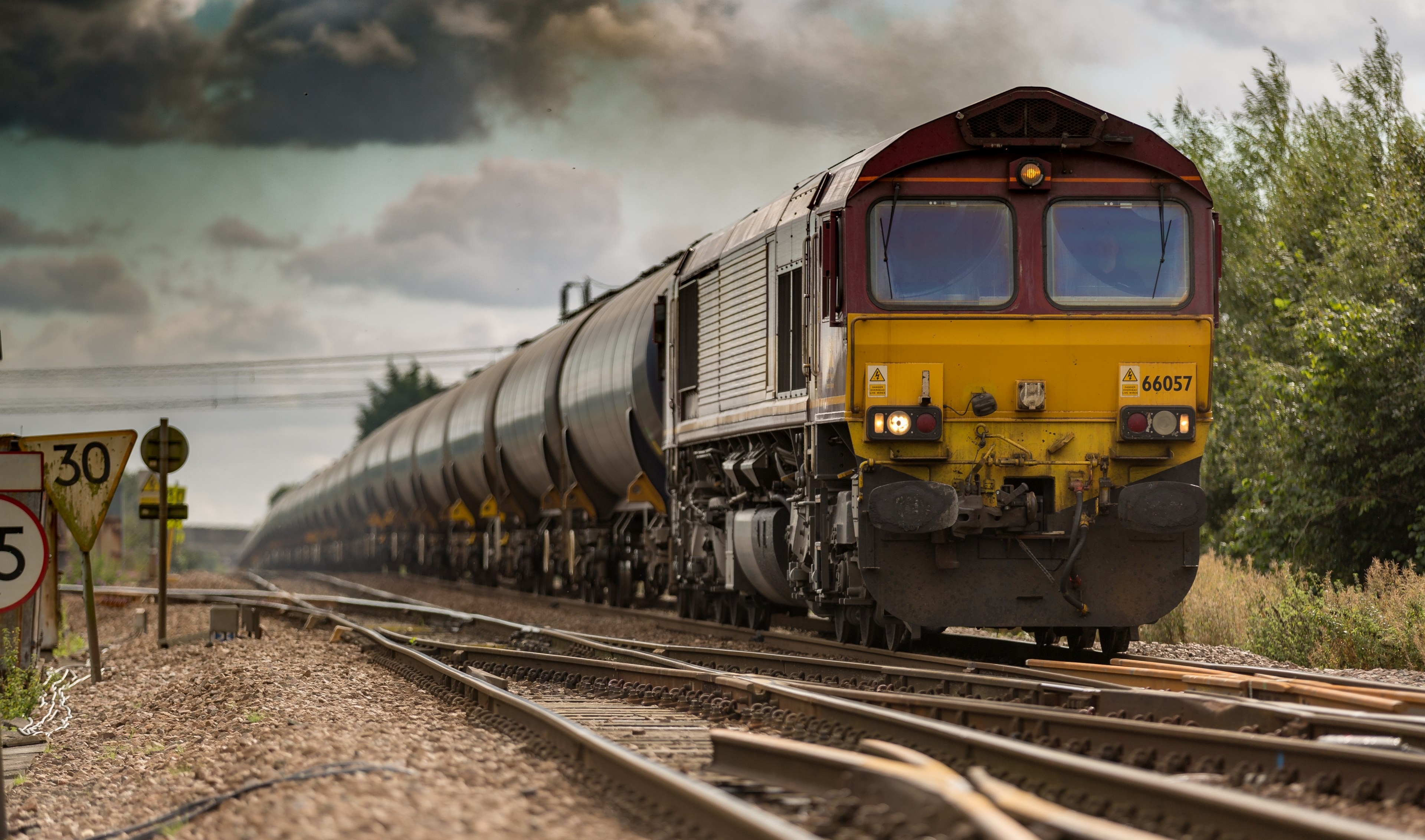 3840x2270 Wallpaper / a moving freight train on railroad tracks on a cloudy day, freight transport 4k wallpaper free download, Desktop