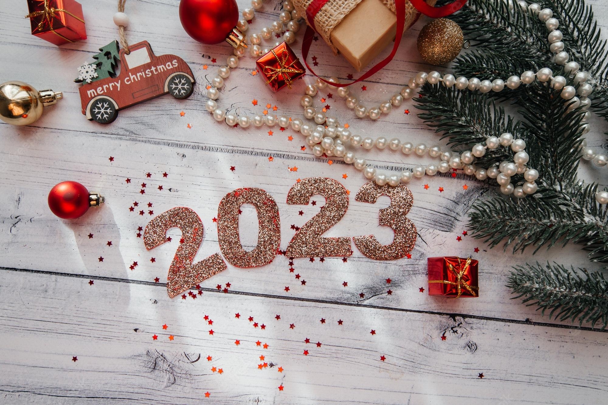 2000x1340 Premium Photo. Numbers 2023 on a wooden background with christmas decorations. selective focus, Desktop