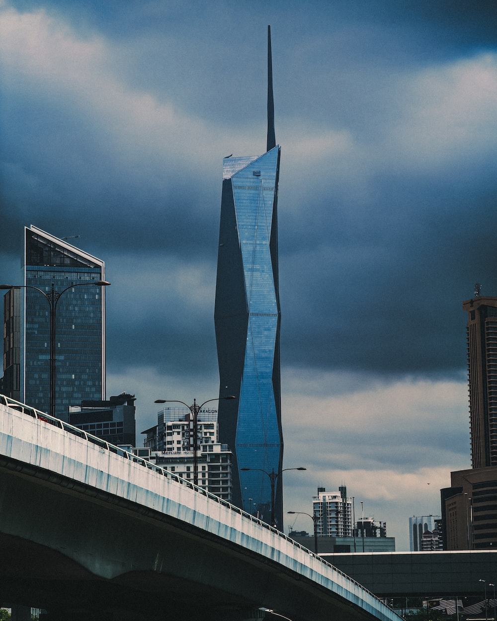 1000x1250 A very tall building towering over a city photo, Phone