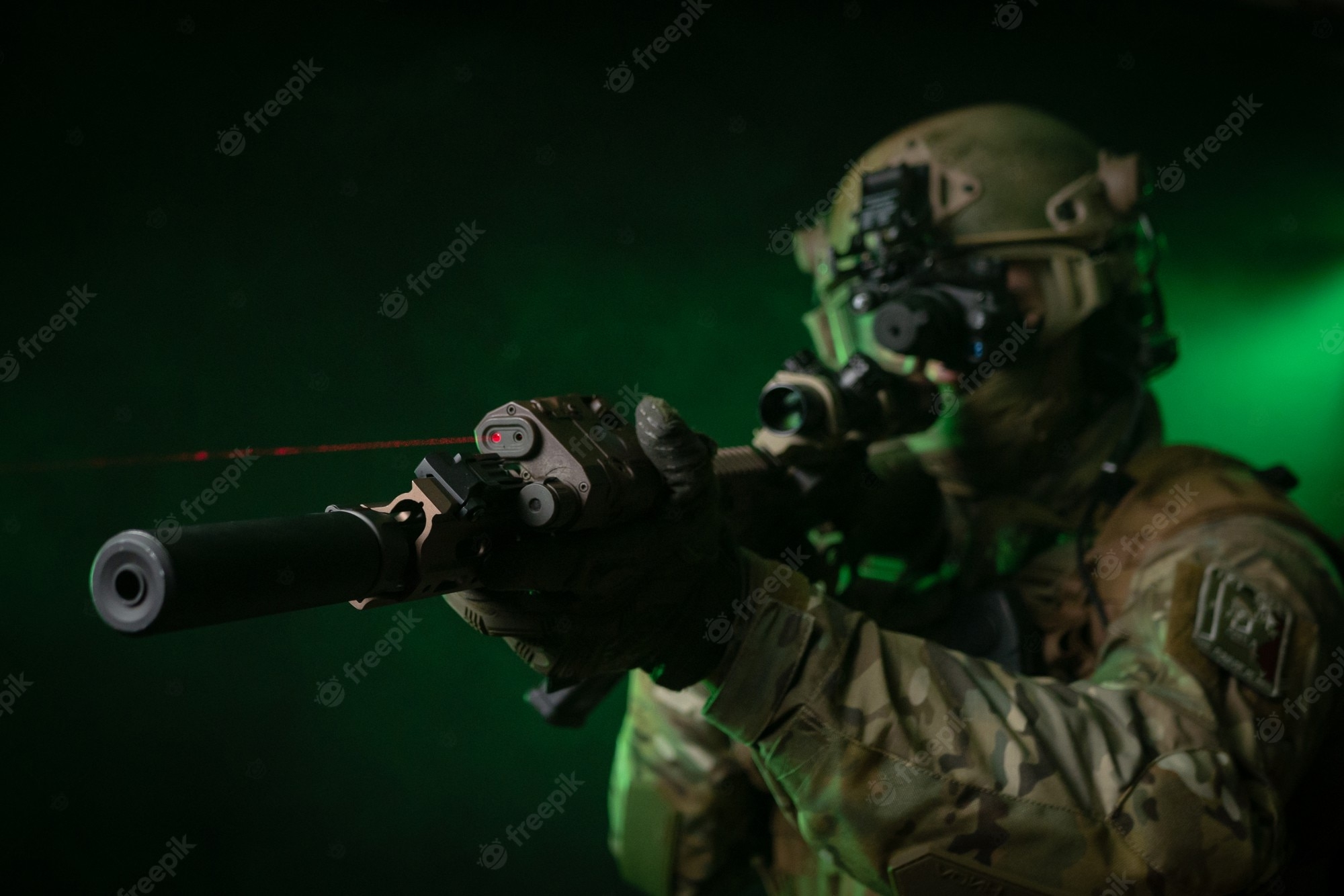 2000x1340 Premium Photo. The soldier in military clothing with a night vision device and on a dark background, Desktop