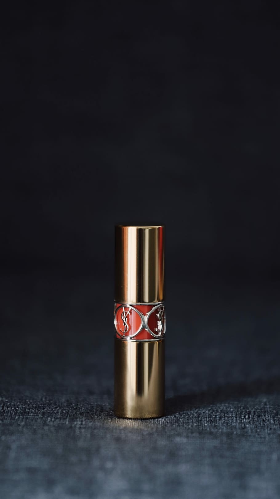 910x1620 HD wallpaper: lipstick bottle on gray surface, Yves Saint Laurent, Phone