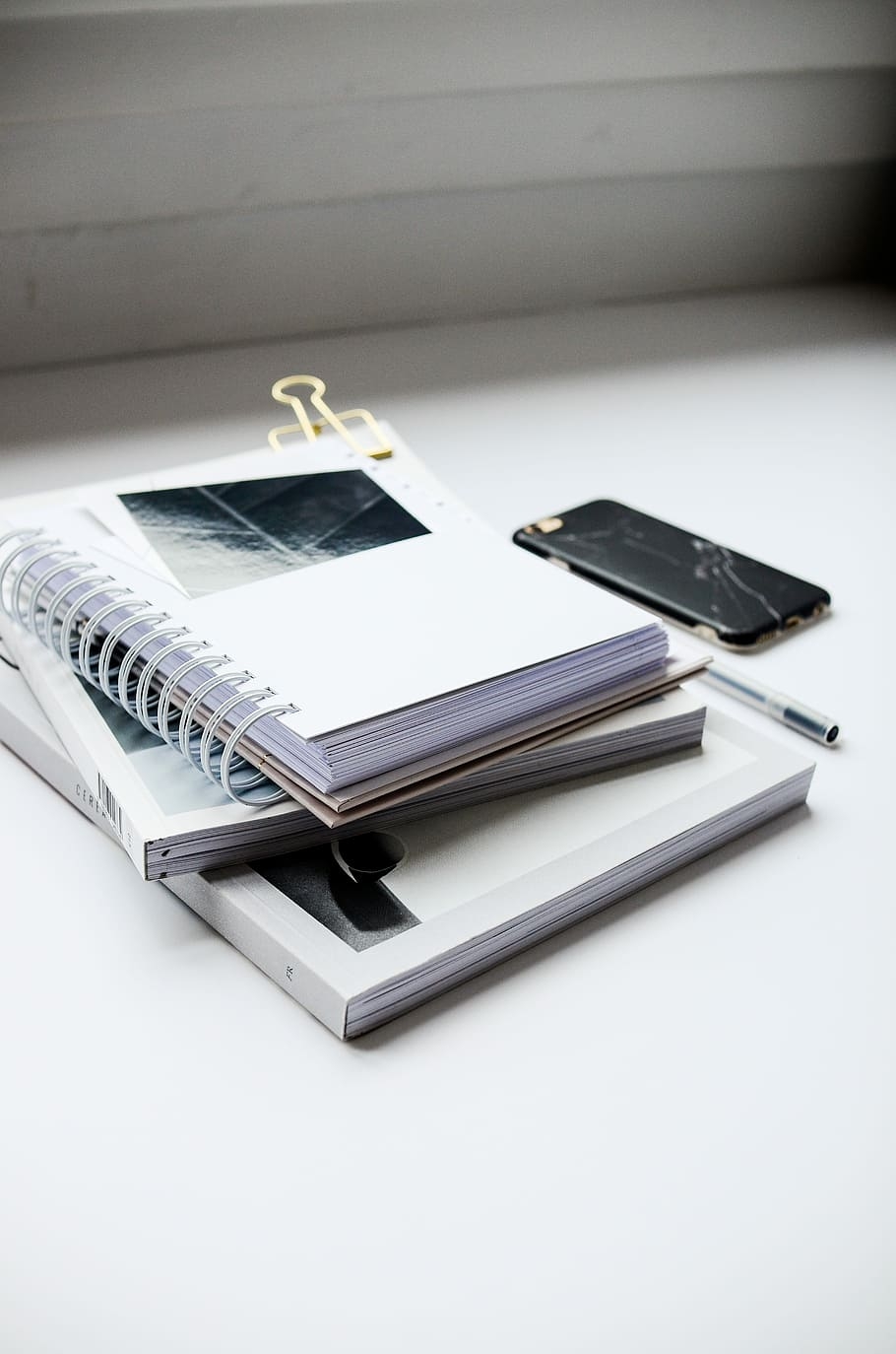 910x1380 HD wallpaper: white spiral notebook beside black smartphone, Phone