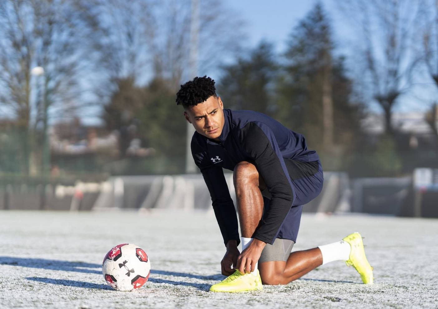 1410x1000 Download Ollie Watkins Fixing His Shoes Wallpaper, Desktop