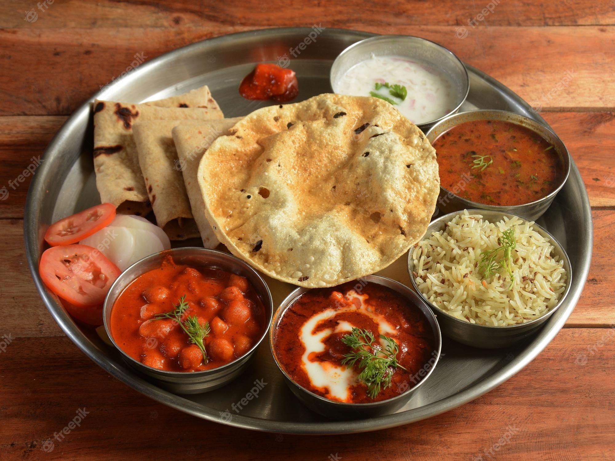 2000x1500 Premium Photo. Punjabi veg thali from an indian cuisine food platter consists variety of veggies lentils jeera rice roti sweet dish curd pickle etc selective focus, Desktop