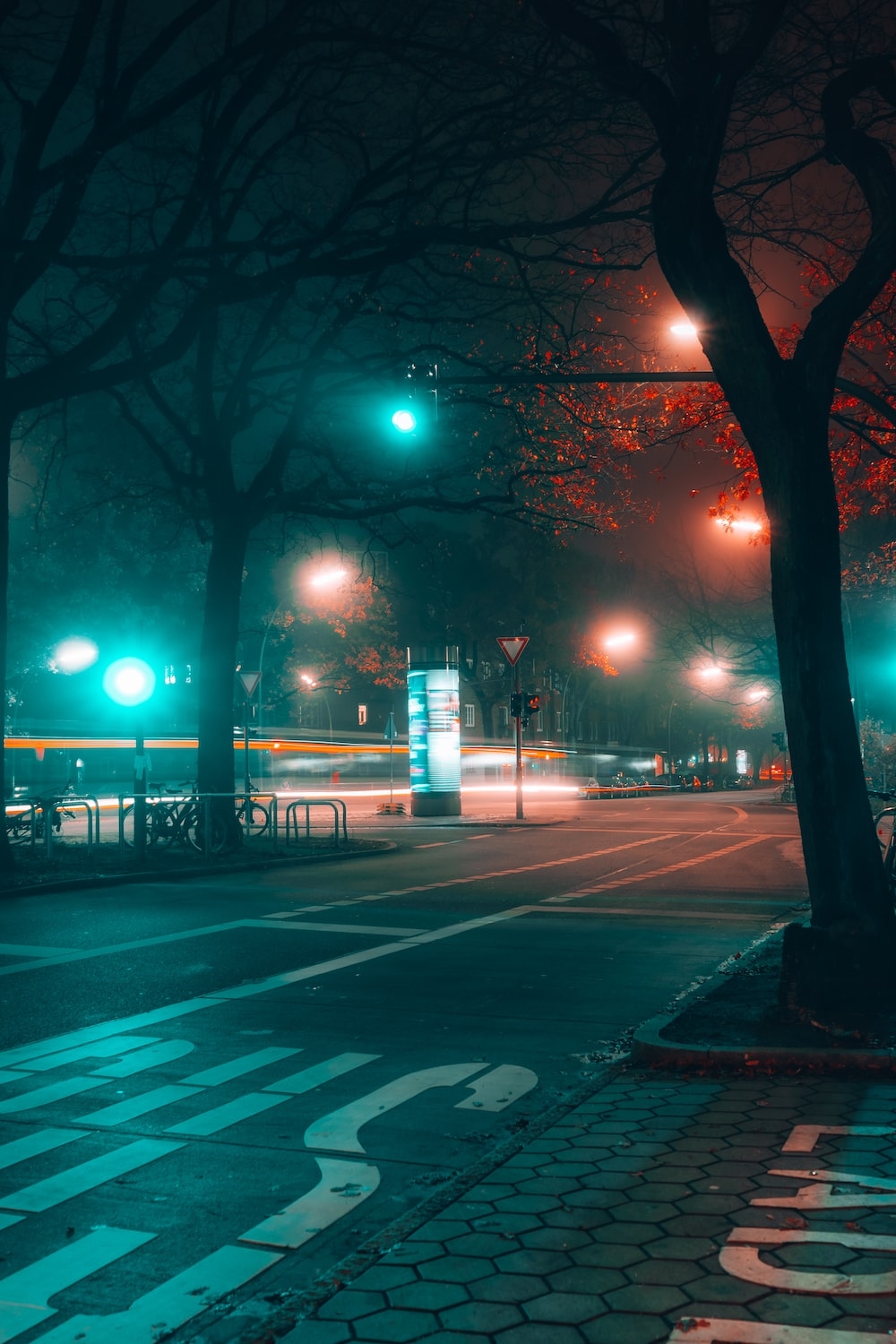 1000x1500 A city street at night with street lights photo, Phone