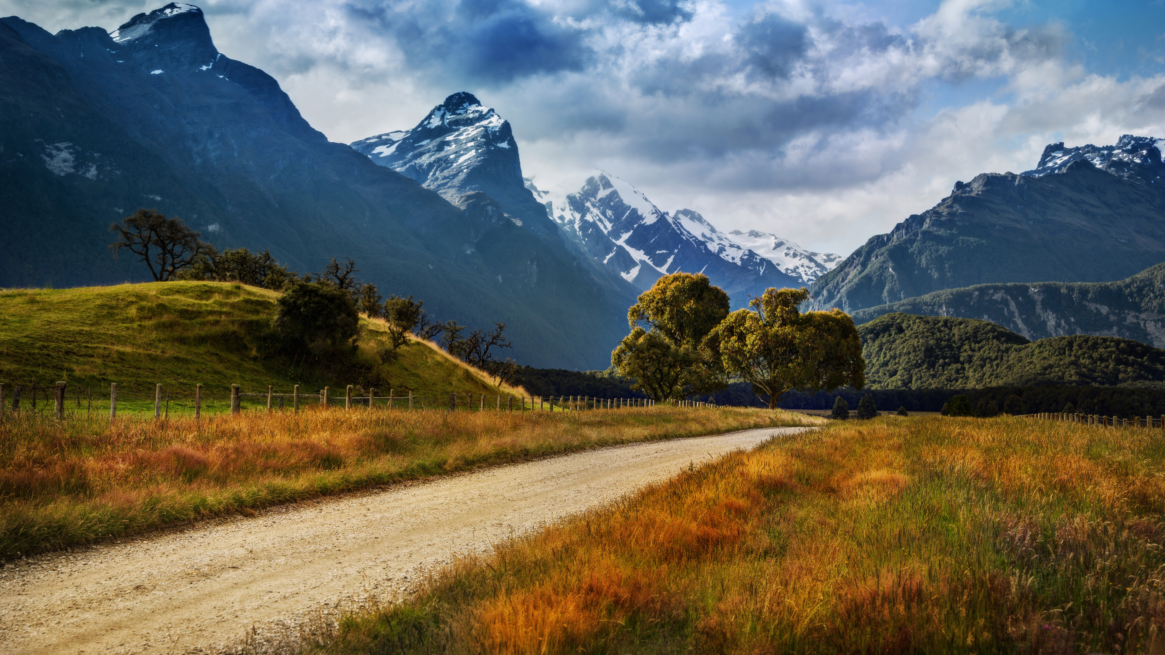 3840x2160 Landscape Of New Zealand Country Road Yellowed Grass, Rocky Peaks Of Mountains With Snow, Dark Clouds Desktop Wallpaper Full Screen, Wallpaper13.com, Desktop