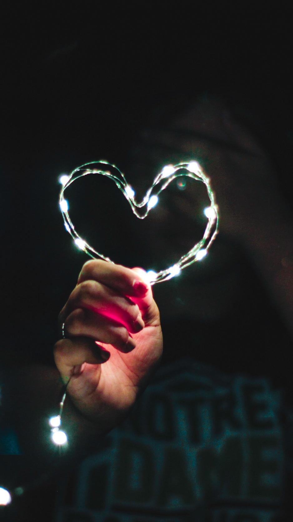 940x1670 Download wallpaper  heart, hand, light, glitter, Phone